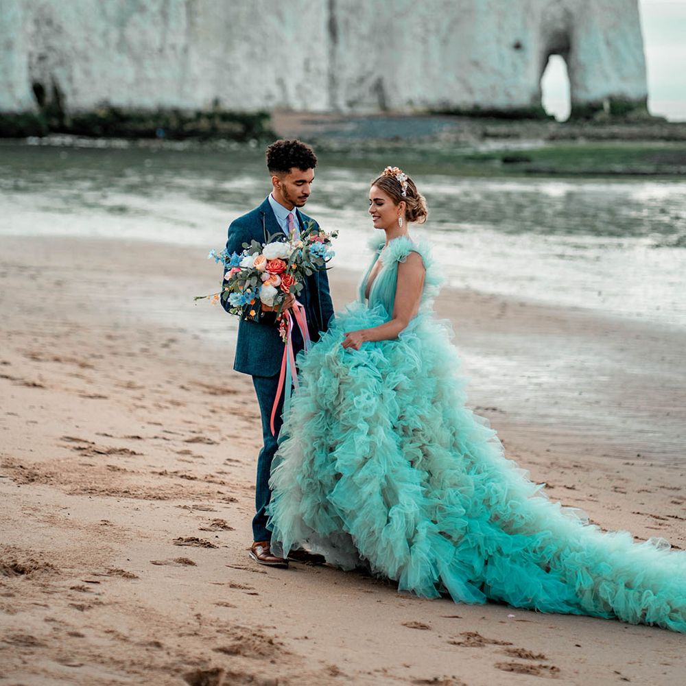 Botany Bay, Kent coastal wedding elopement with bride in a ruffle wedding dress and groom a wool suit 