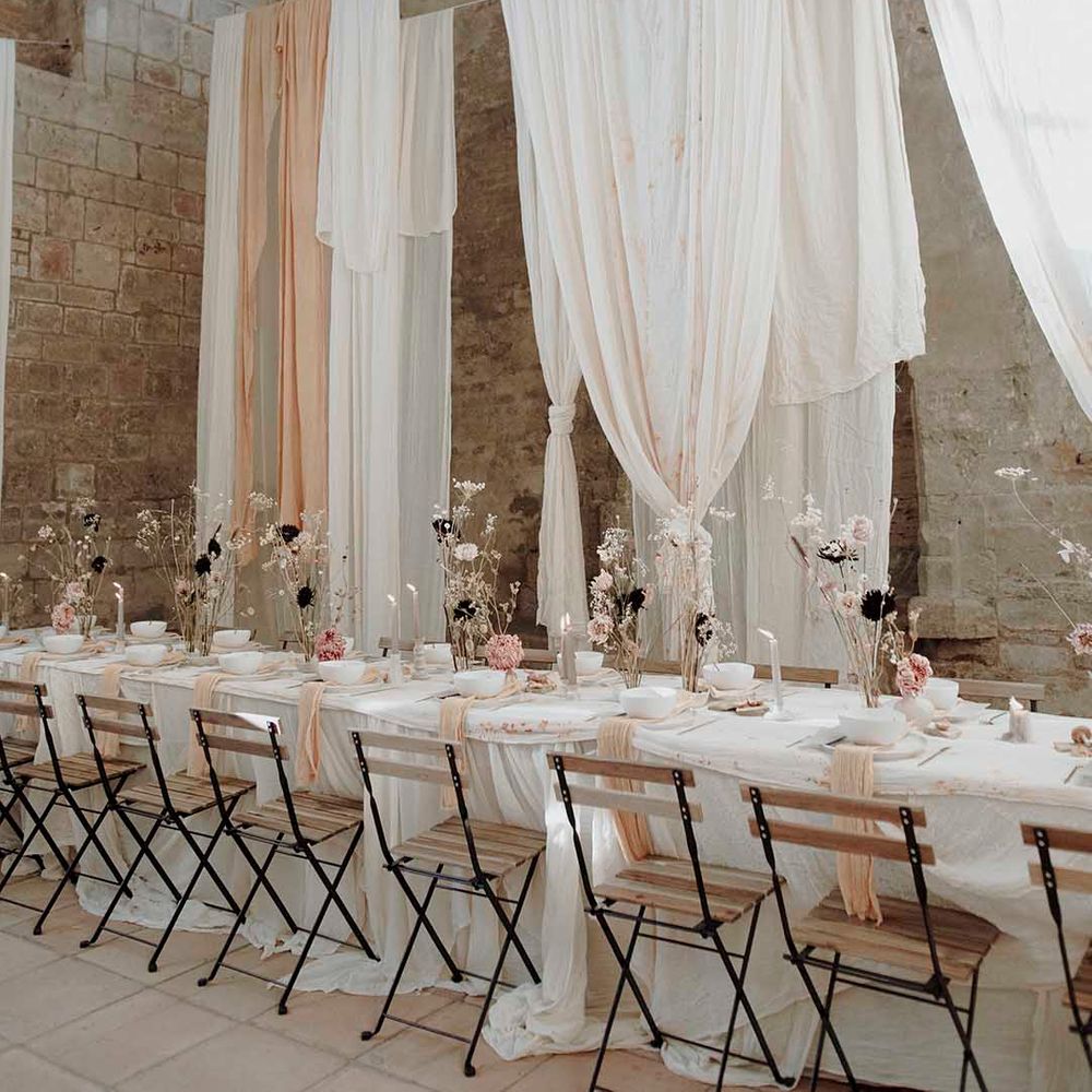 Minimalist wedding reception at Blackfriars Priory with drape installations, dried flowers and candles 
