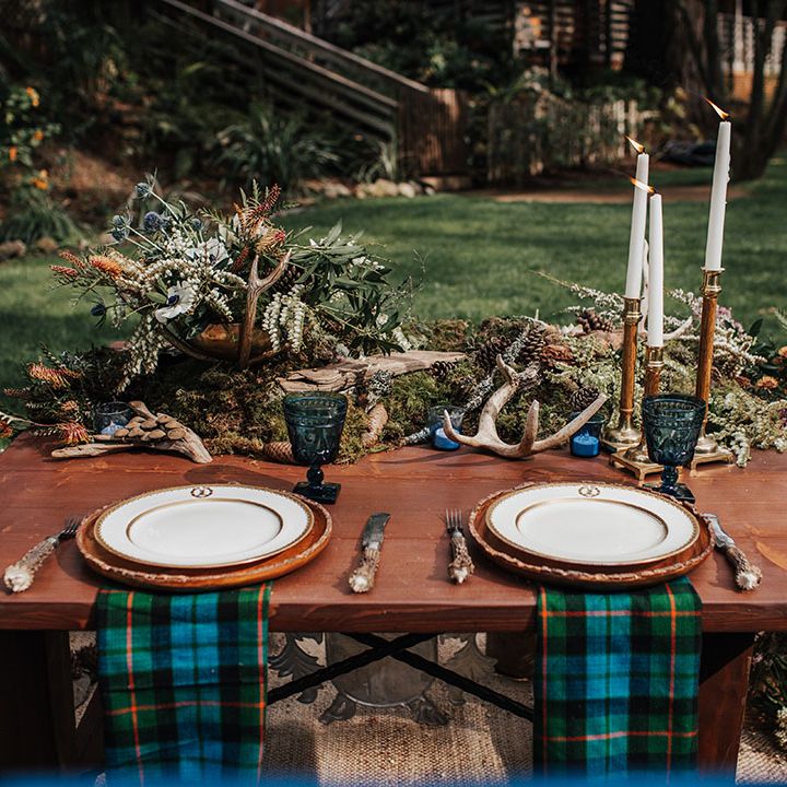 Sweetheart table with blue and green wedding, tartan napkins, antlers, moss and candlesticks table decor 