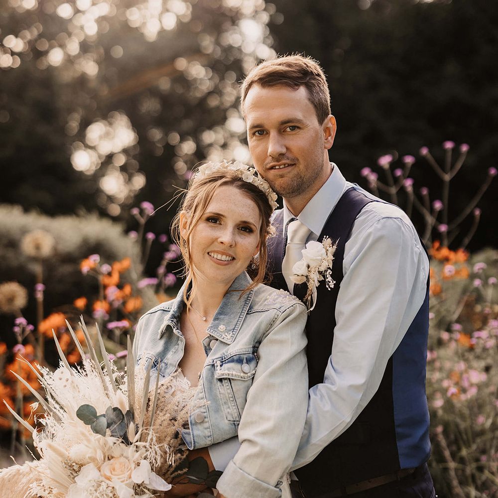 Groom wraps his arms around bride on their wedding day
