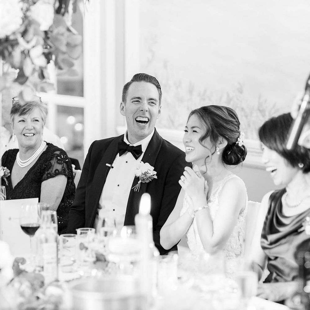 Black & white image of bride & groom during wedding reception