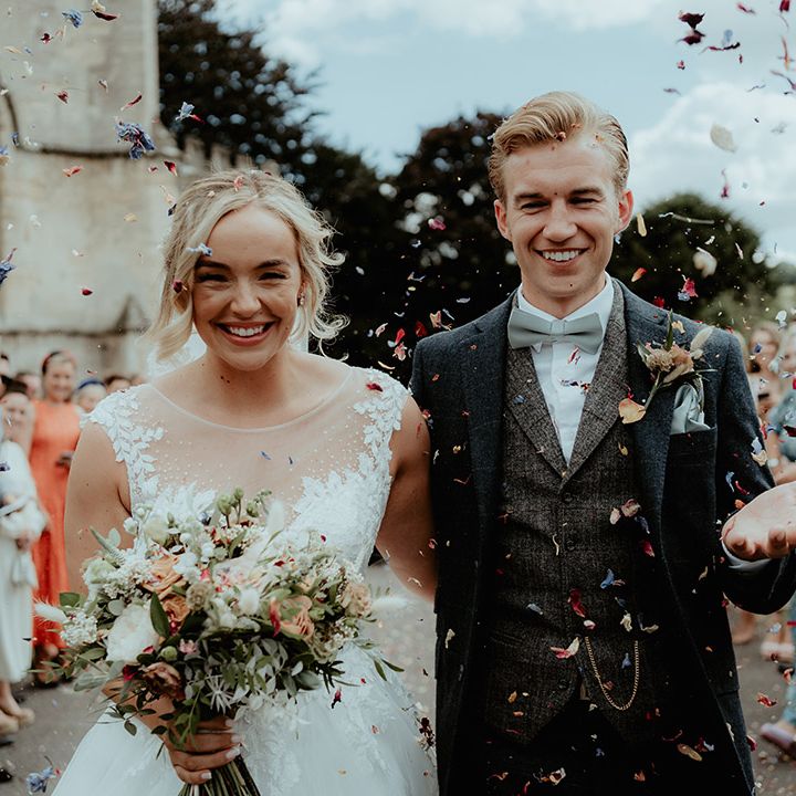 Bride and groom have confetti exit after their church wedding ceremony 