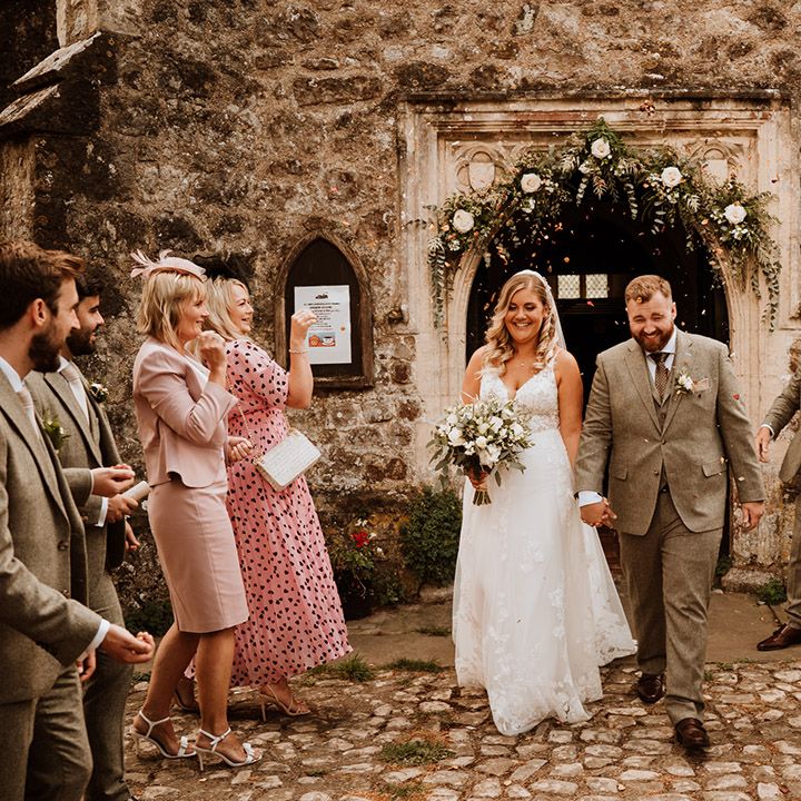 The bride and groom have a confetti moment as they exit church 
