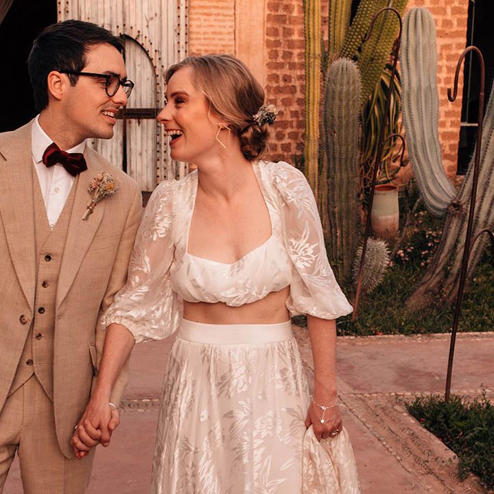 Bride in Grace Loves Lace bridal separates with the groom in three piece cream suit with red bow tie and dried flower buttonhole 