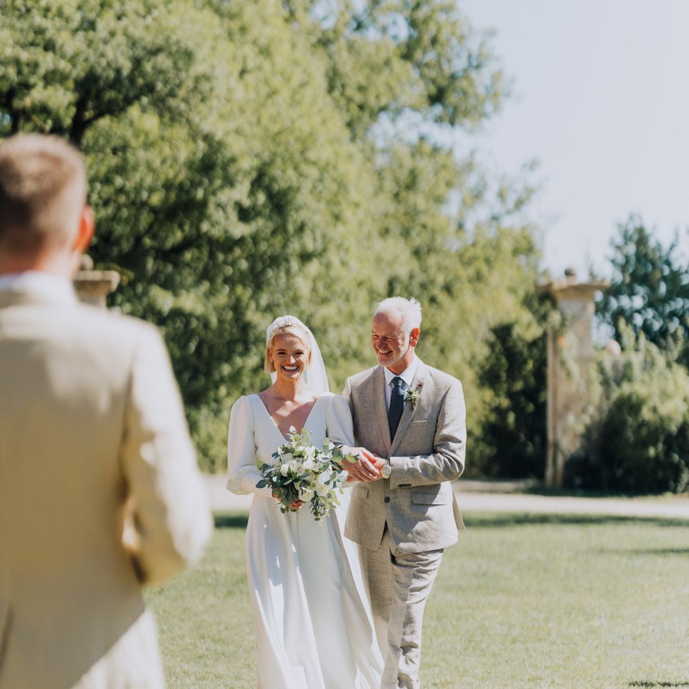 father of the bride walking his daughter down the aisle at French destination wedding 