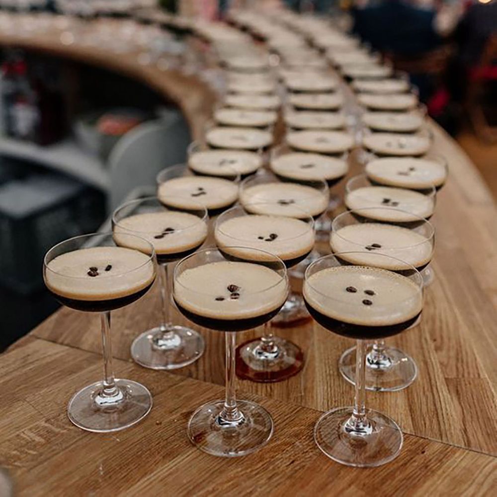 Large amount of espresso martinis on a bar by Epic Love Story Photography 