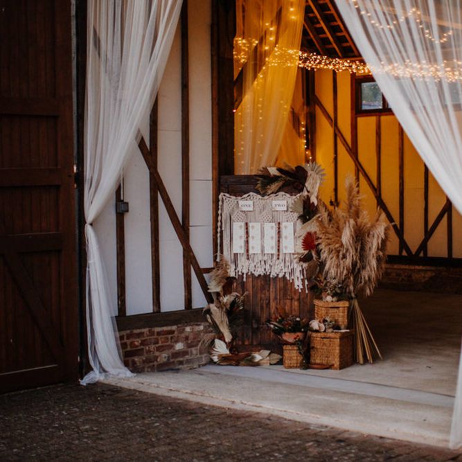 Rustic barn wedding with macramé table plan and sparkly lights