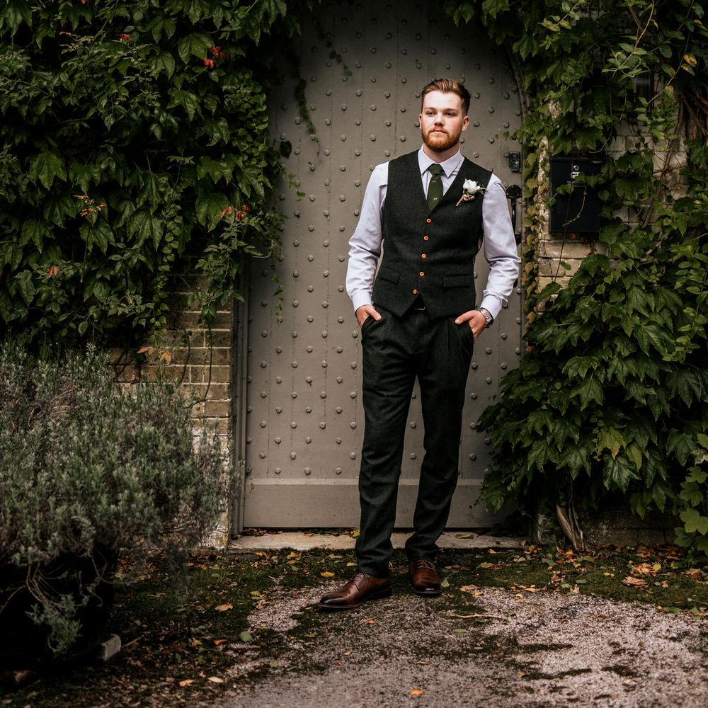 Groom in front of doorway 