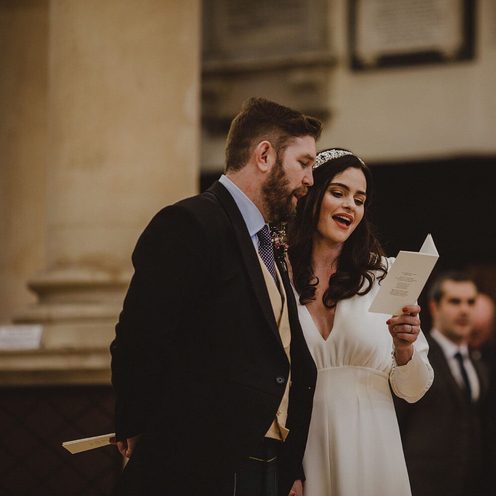 Bride and groom singing holding each other at wedding ceremony 