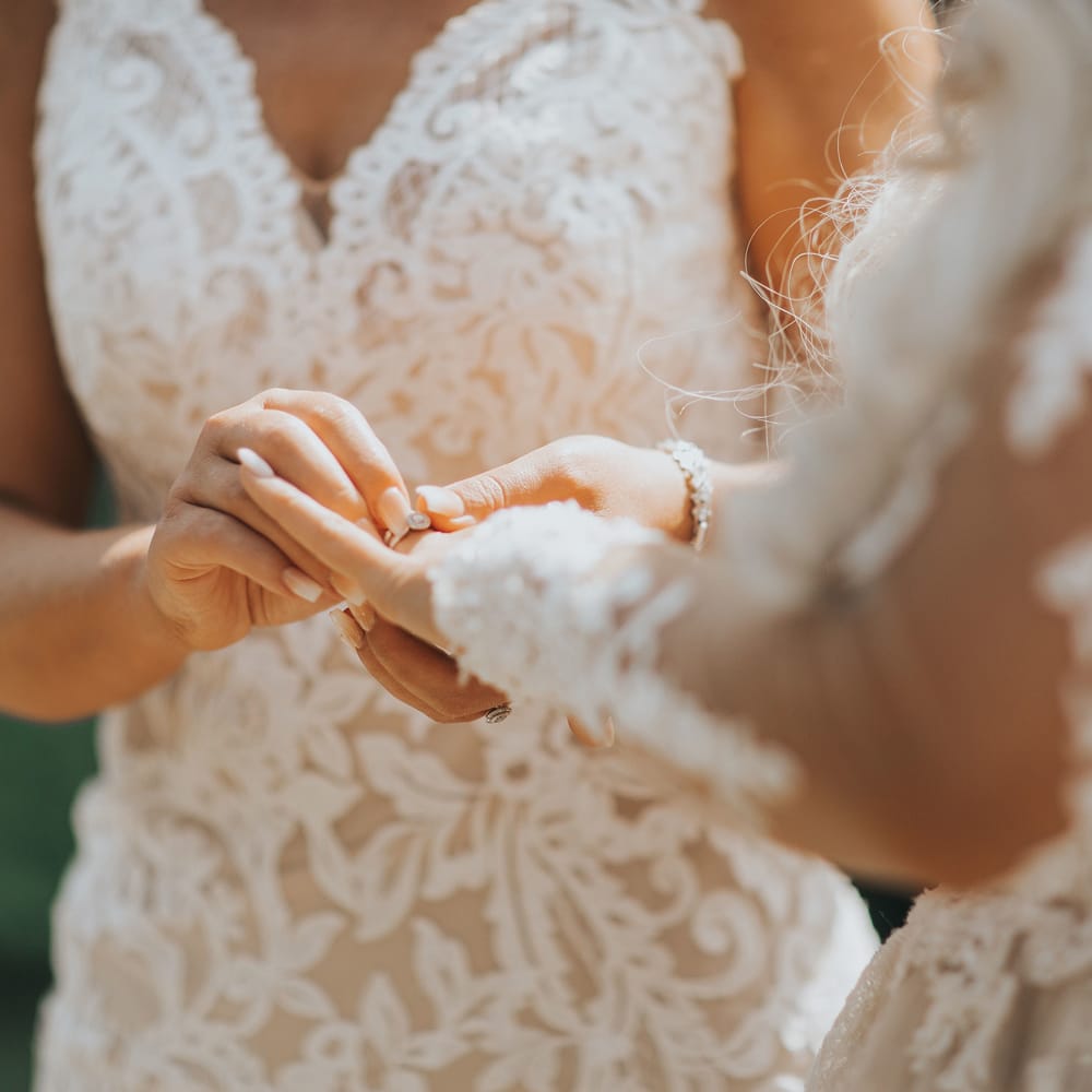 A lesbian couple exchange rings at their wedding ceremony at Crab and Lobster Fairytale Wedding.