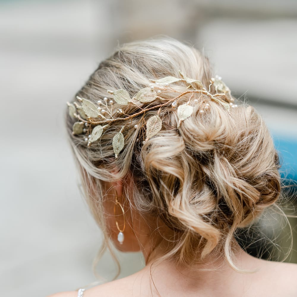 loosely pinned wedding hairstyle with leaf and pearl headdress 