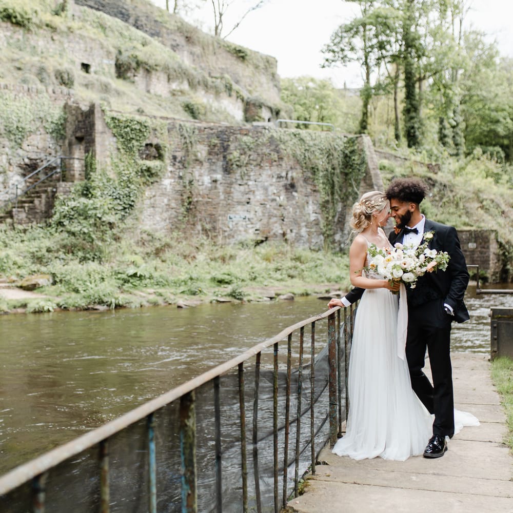 Bride and groom portrait at Torr Vale Mill situated on the banks of the River Goyt in New Mills Derbyshire