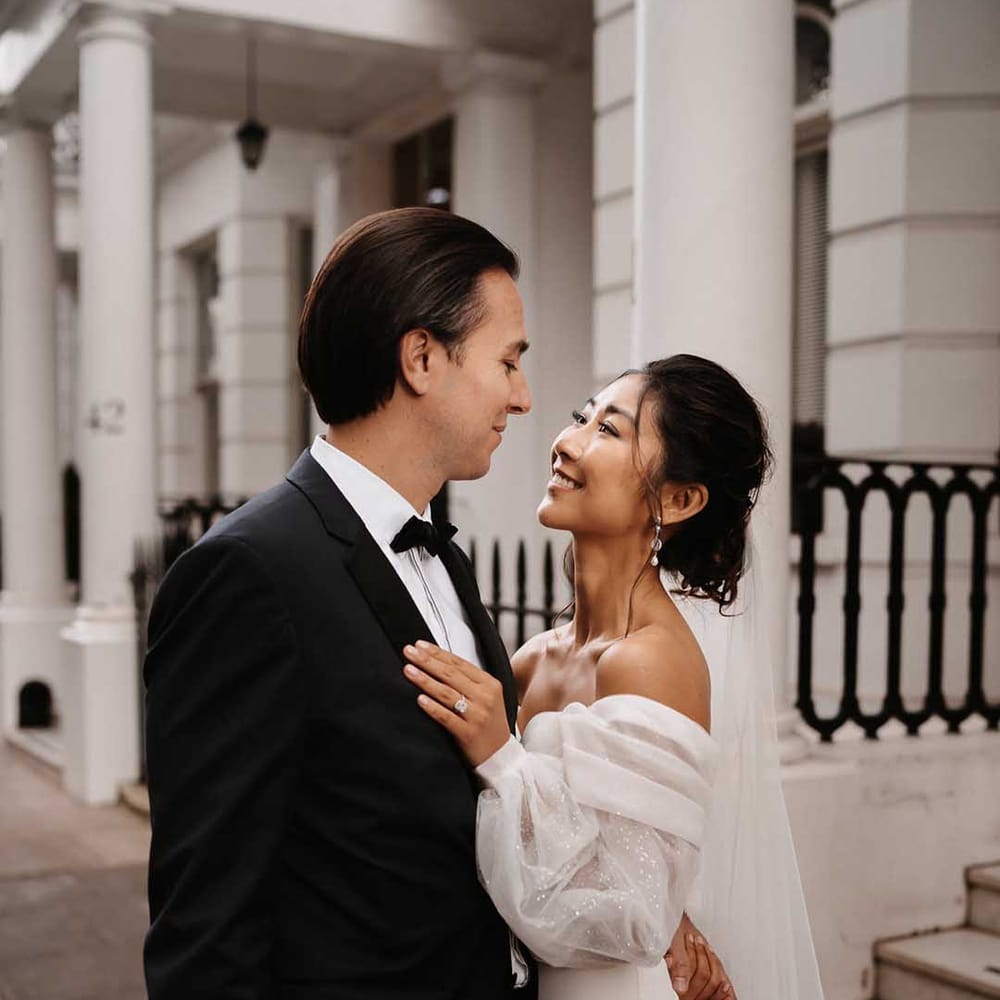 Groom in luxury black suit with white shirt and Brides detailed sparkles in her chiffon sleeves