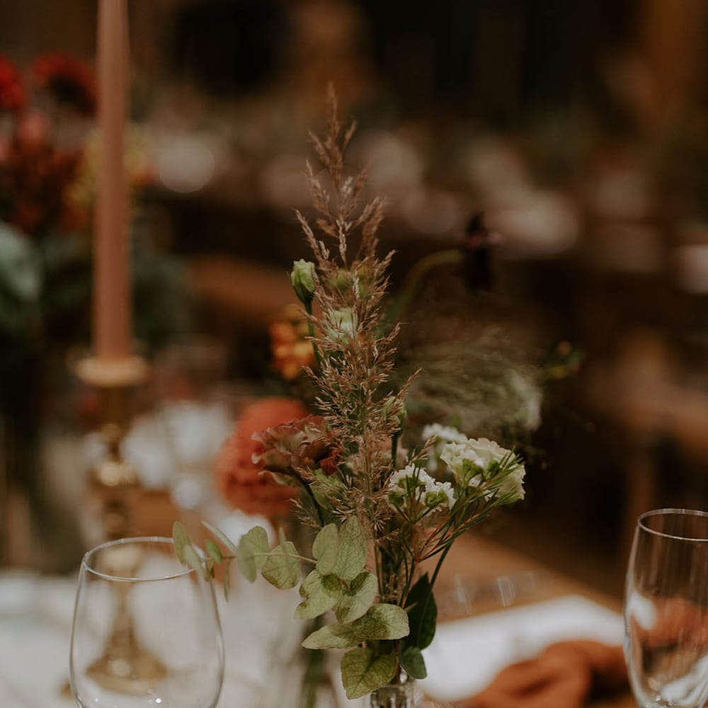Foliage wedding table decor in glass vase