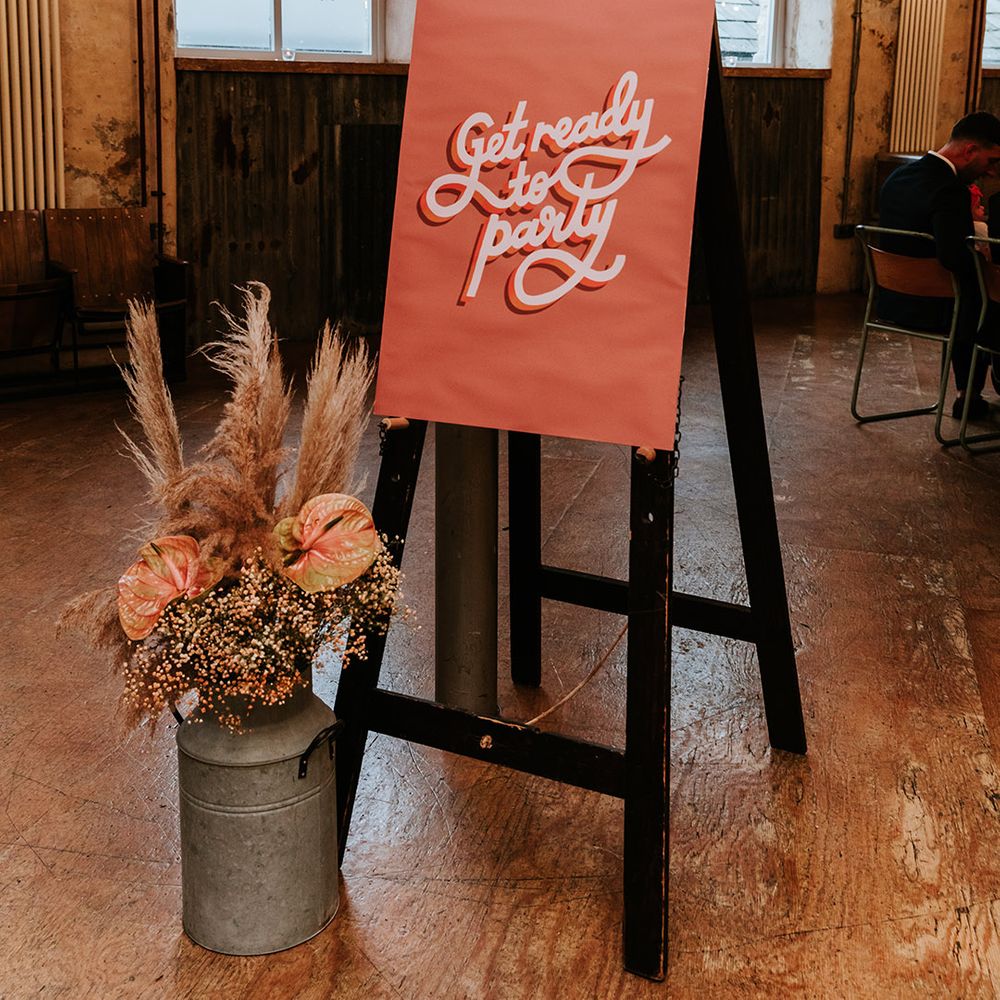70s inspired wedding sign reading 'get ready to party' with autumnal flowers