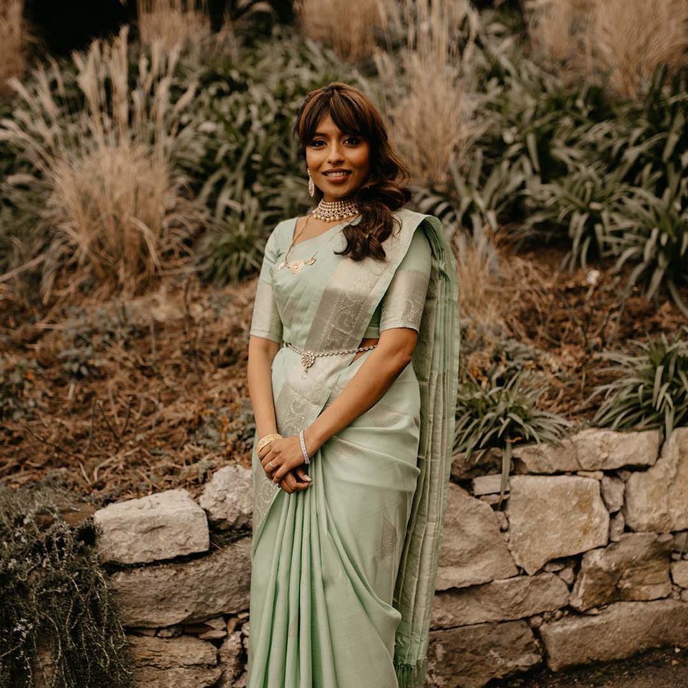 Bride in mint green saree on the grounds of The Petersham Hotel in Richmond