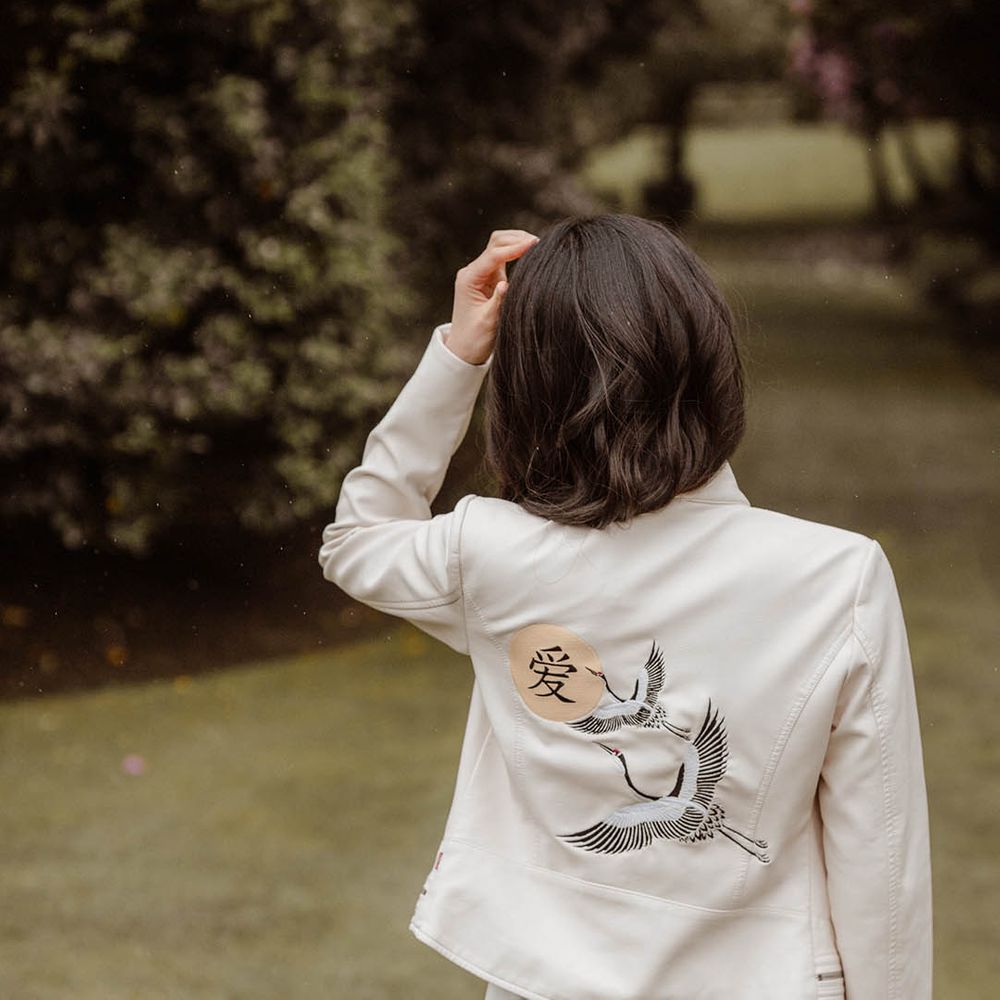 Japanese wedding with bride in a white jacket with East Asian motif 