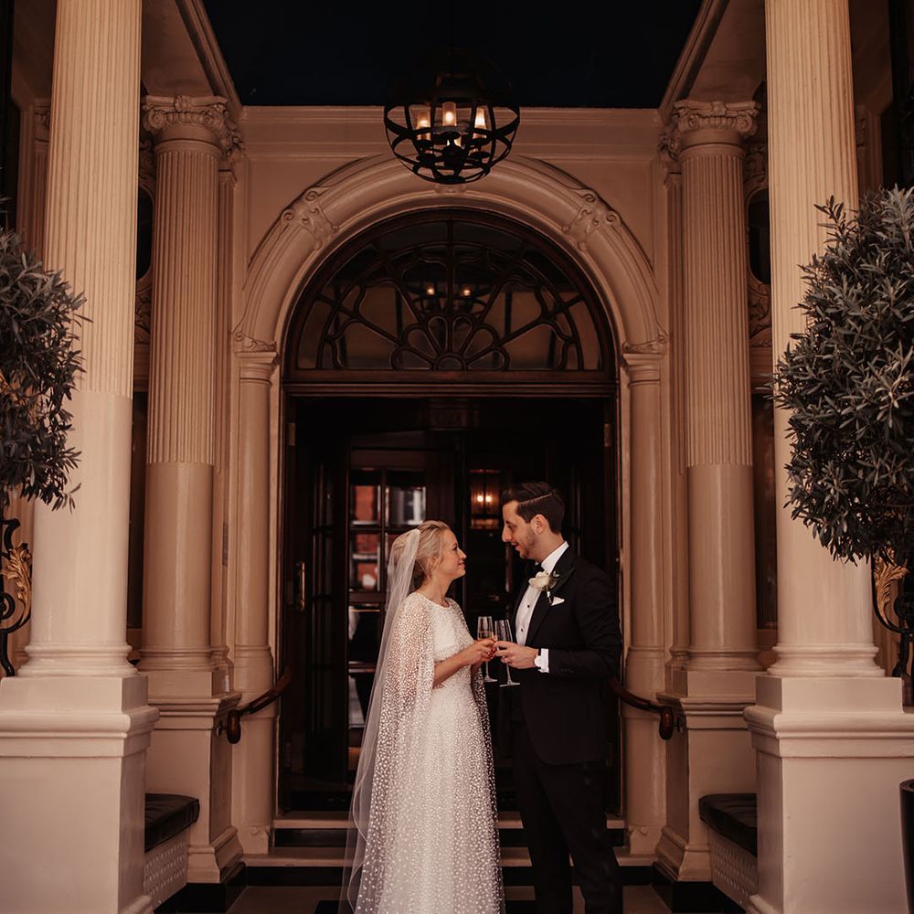Bride and groom have an intimate moment and share a drink together for their hotel city wedding 