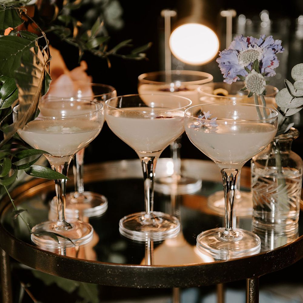 Tray full of wedding cocktails with edible flowers 