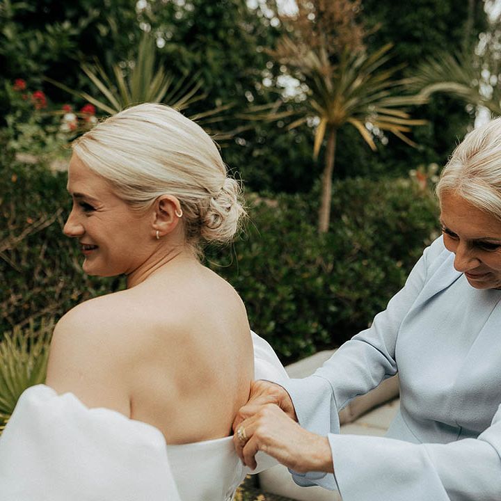 Mother of The Bride helps do up her Jesus Peiro wedding dress 