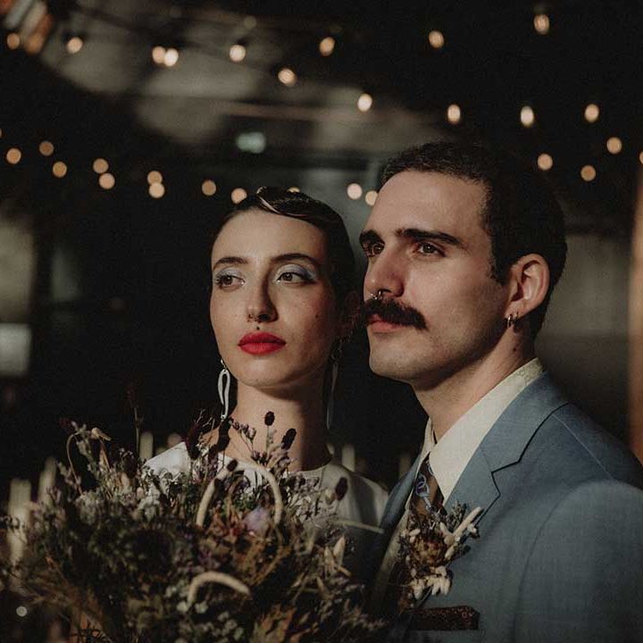 Gabriel in powder blue Gucci suit and Lisa wearing bright red lipstick 