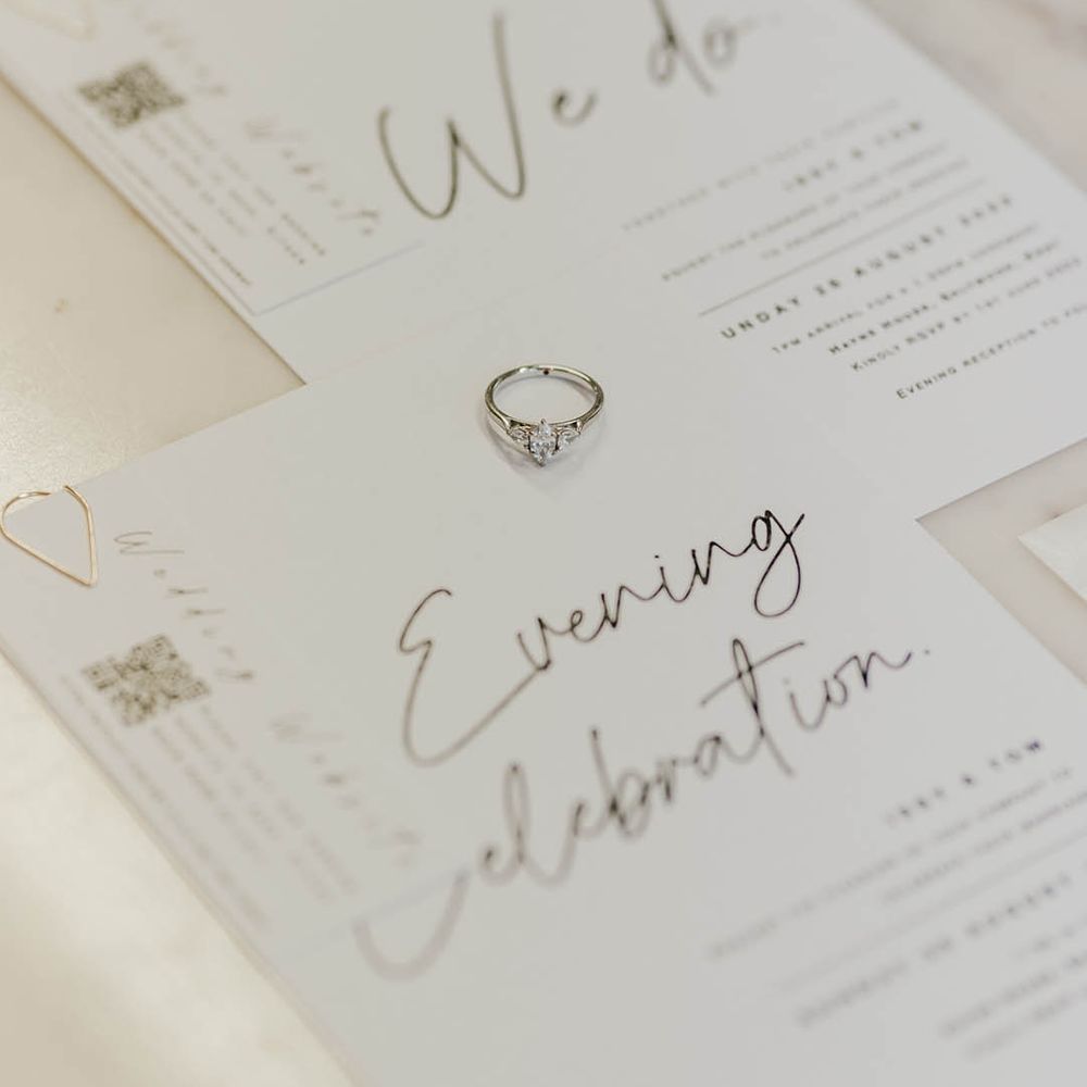 Trinity stone diamond engagement ring on the monochrome minimal wedding stationery 
