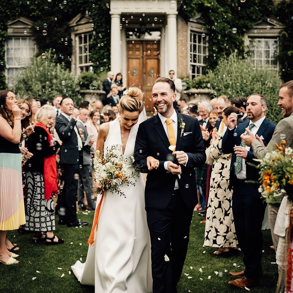 The bride and groom exit their wedding ceremony to bubbles instead of confetti 