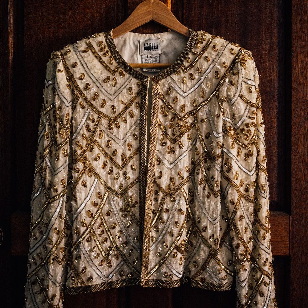 Bride's sparkly gold beaded and sequin cover up jacket for the wedding reception 