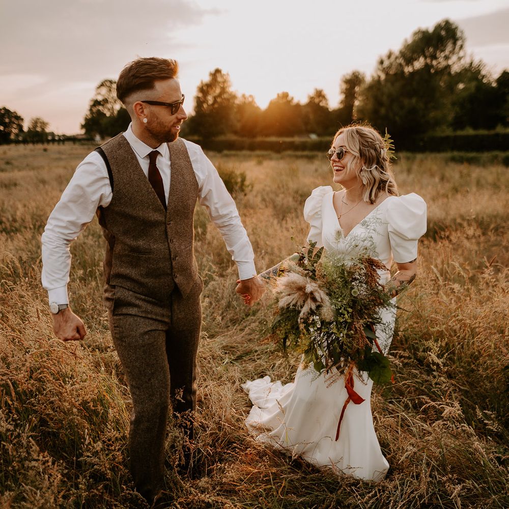 Golden hour wedding photo of the bride and groom as the sun begins to set 