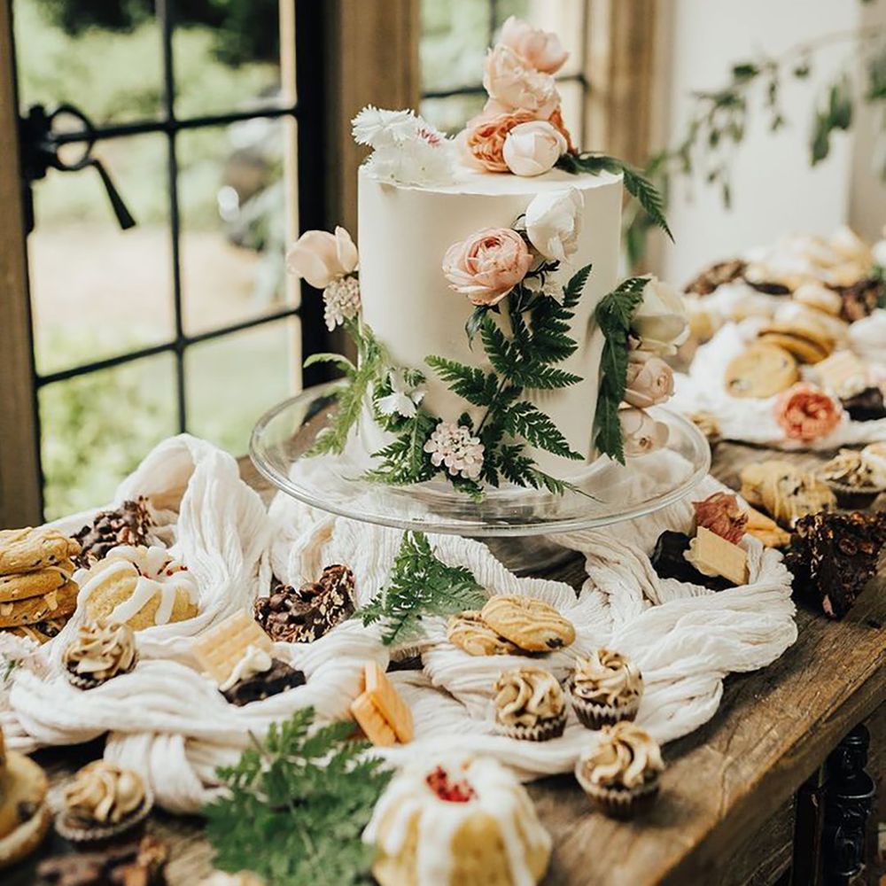 Pastel wedding dessert table with wildflower pressed wedding cake for spring wedding 