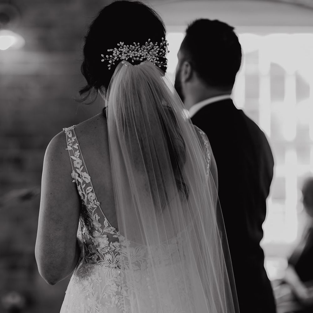Bride wearing pearl crystal hair piece and veil 
