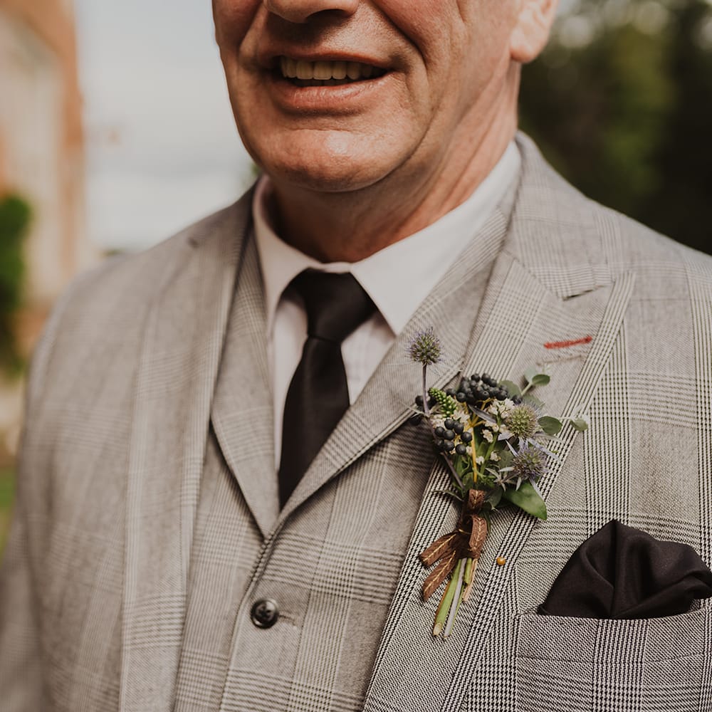 Father of the groom buttonhole and check suit 