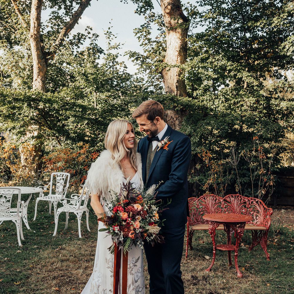 Bride & groom stand outside on wedding day 