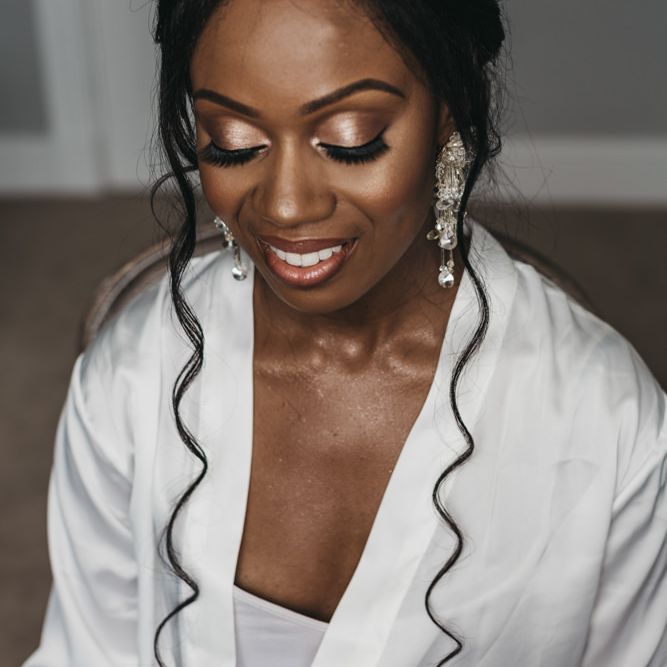 Beautiful Black bridal makeup with chandelier earrings, highlighter and shimmer eyeshadow 