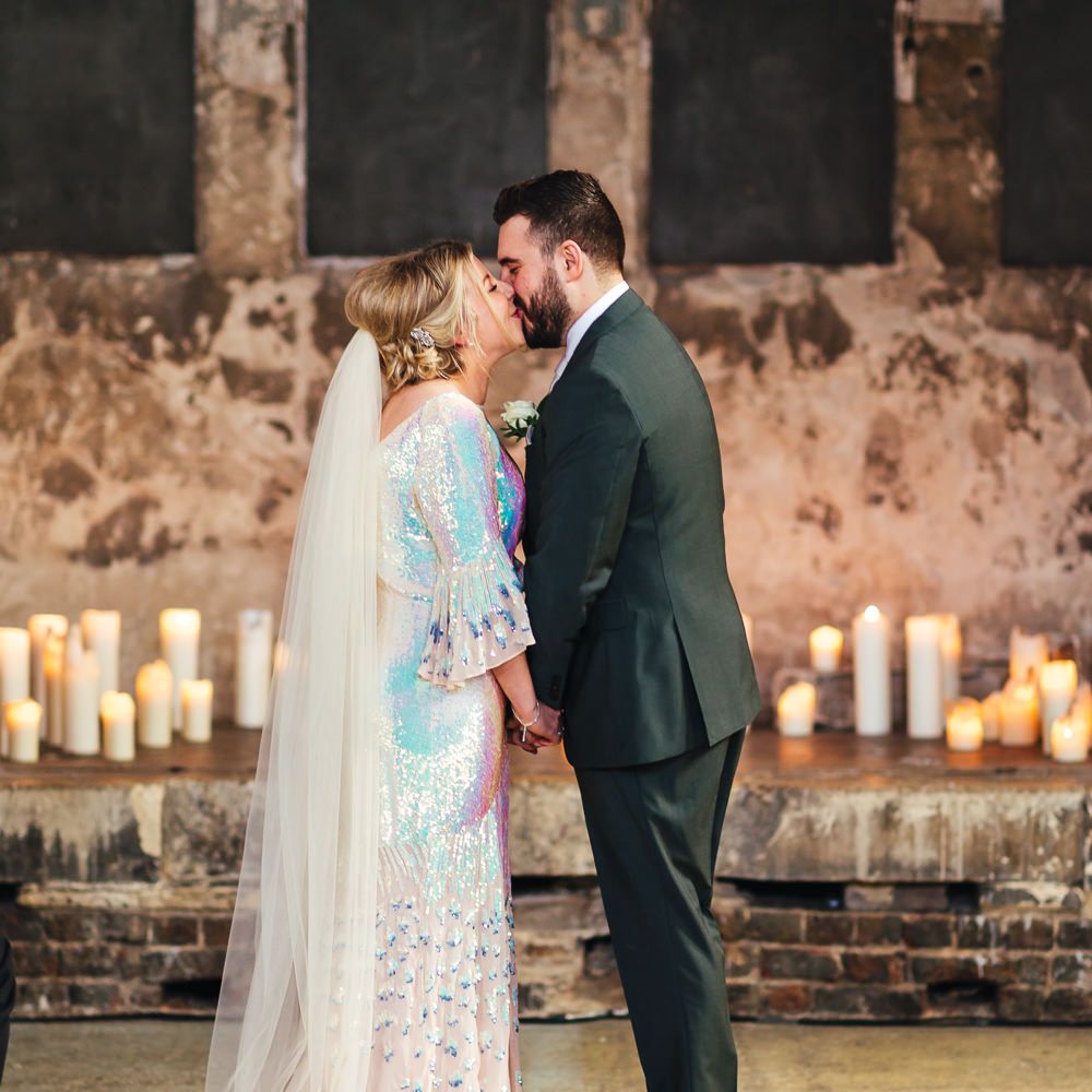 Bride & groom kiss during wedding ceremony
