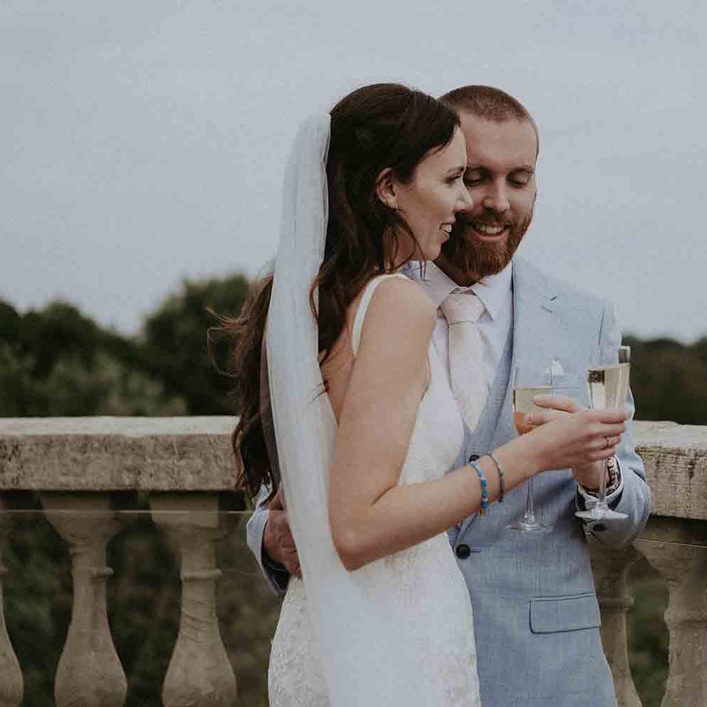 Bride and groom share a toast at Pylewell Park wedding