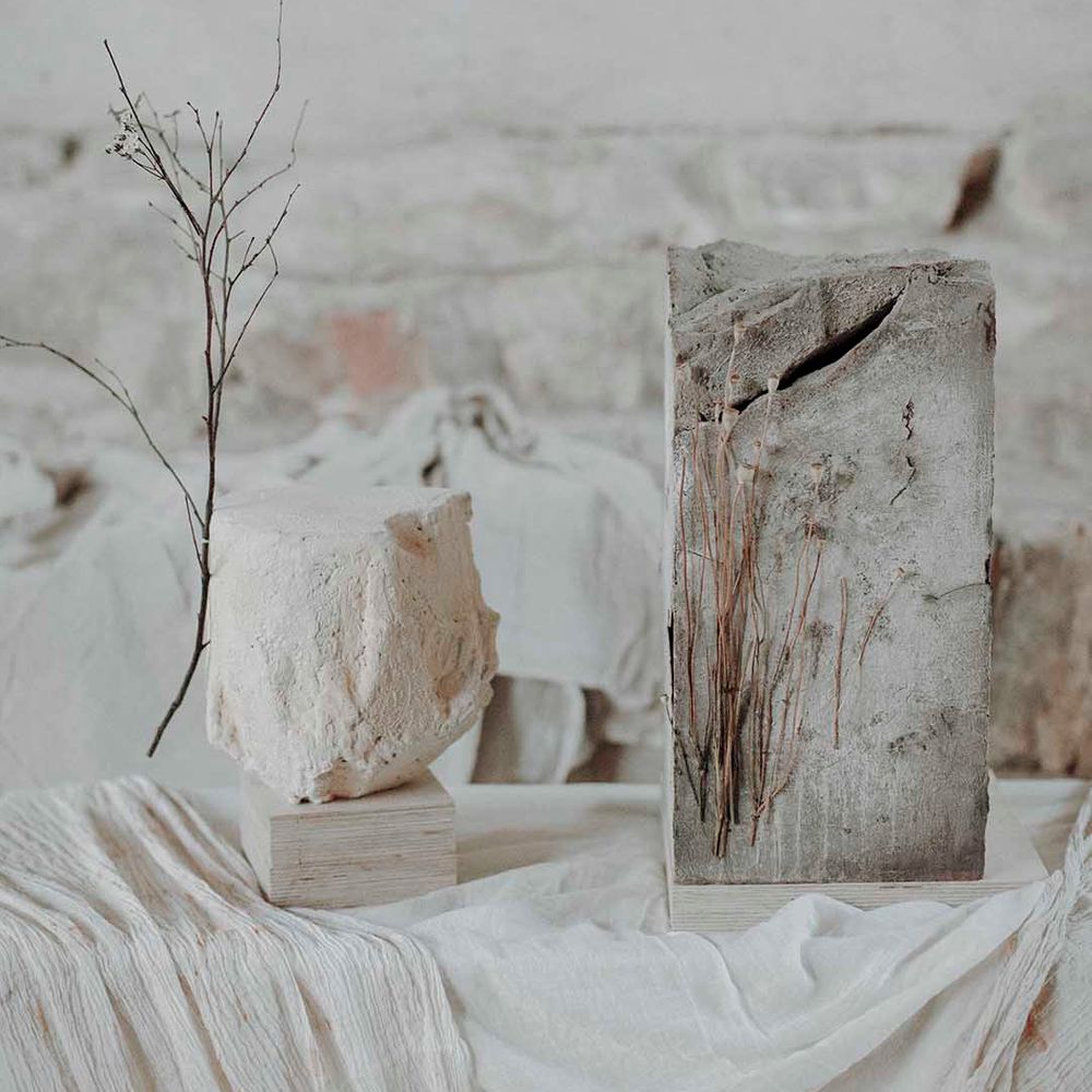 Grey and white concrete wedding cakes with dried flower stems 