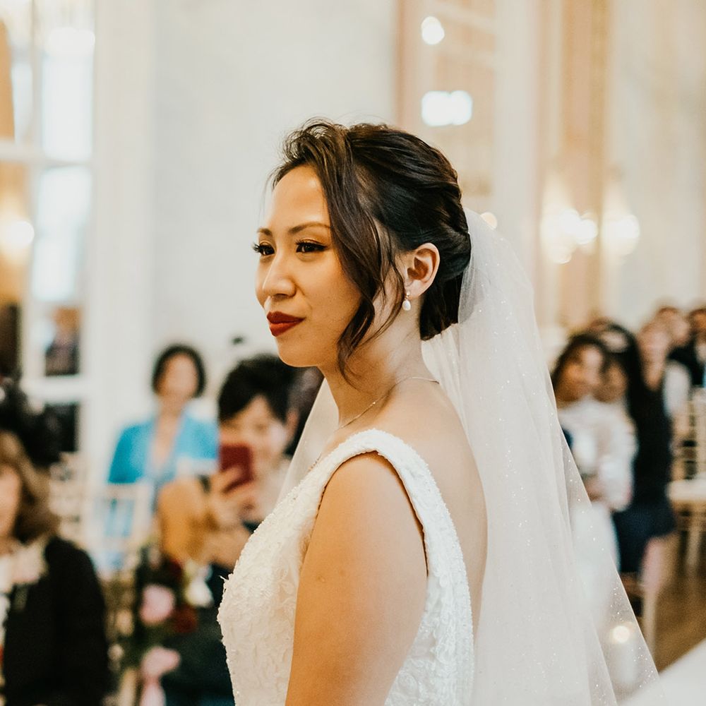 Bride with pinned undo and drop pearl earrings