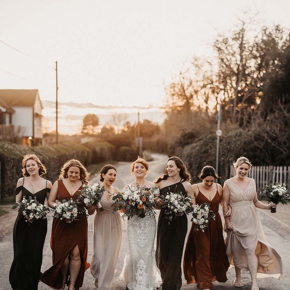 Bridesmaids in cream, rust and brown dresses earth toned, with bride in lace Maggie Sottero wedding dress 