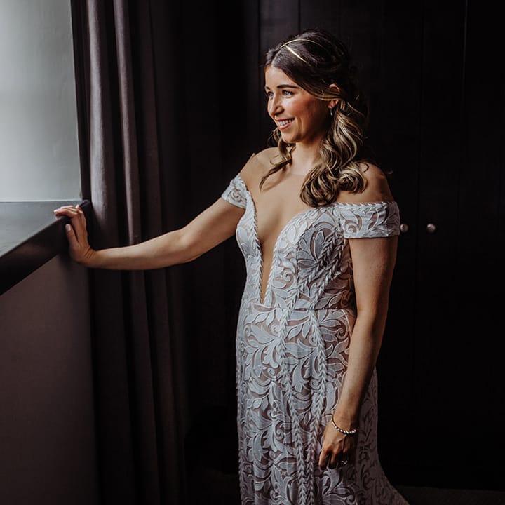 Bride in an off the shoulder boho lace wedding dress 