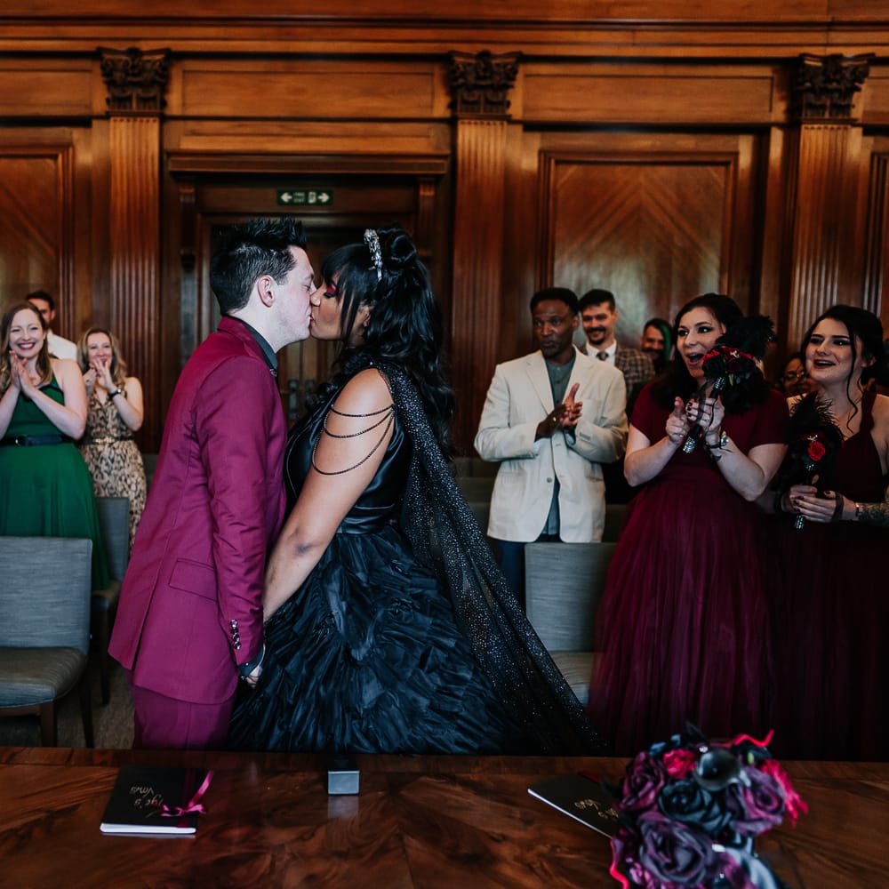 Bride & groom kiss during Town Hall wedding ceremony 