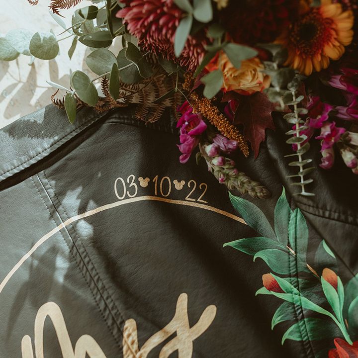 Gold personalised leather jacket bridal cover up for Disney theme wedding at Trevenna Barns wedding venue 