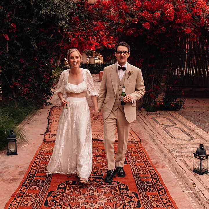 Destination in Marrakech, Morocco with the bride in two piece set and groom walking together 