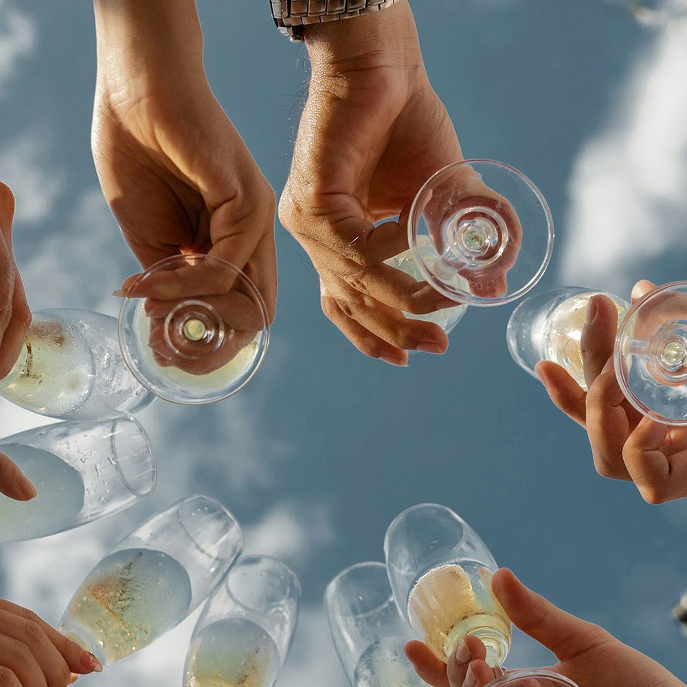Stock image of a group of friends cheersing with prosecco outdoors