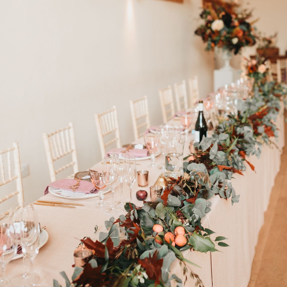 Millbridge Court top table wedding flowers with foliage and apples 