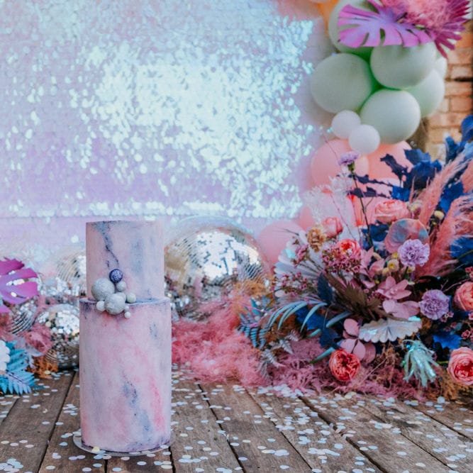 Pastel marble effect wedding cake with sequin backdrop 
