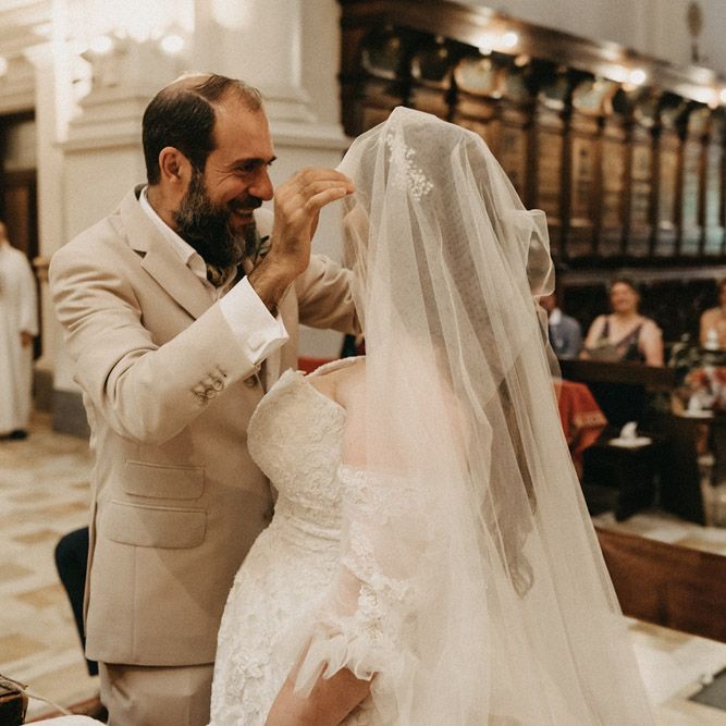 Groom lifting Bride's Blossom & Bluebird veil