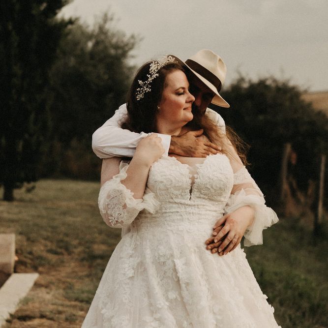 Bride and groom hug in Tuscany