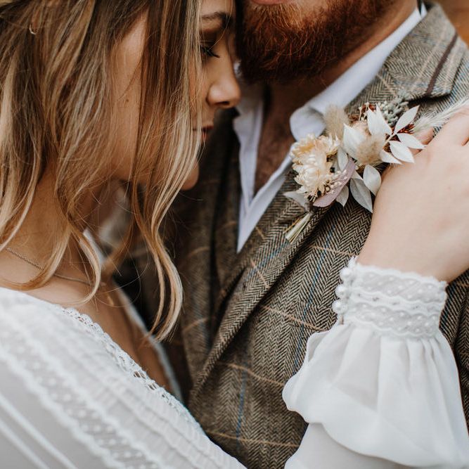 Close up shot of bride and groom at boho luxe wedding