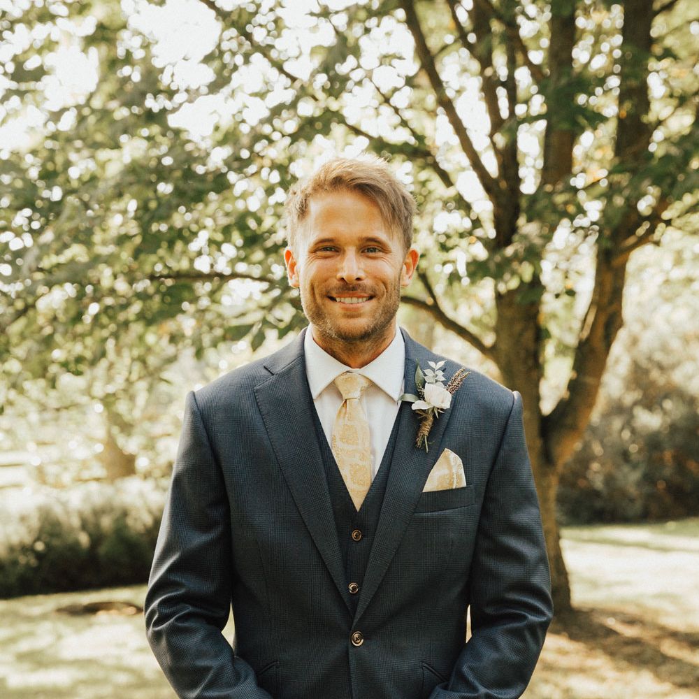 Groom in bespoke navy subtle check three piece suit